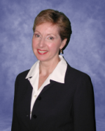 Photograph of our founder, Anne Hull in a navy blue jacket